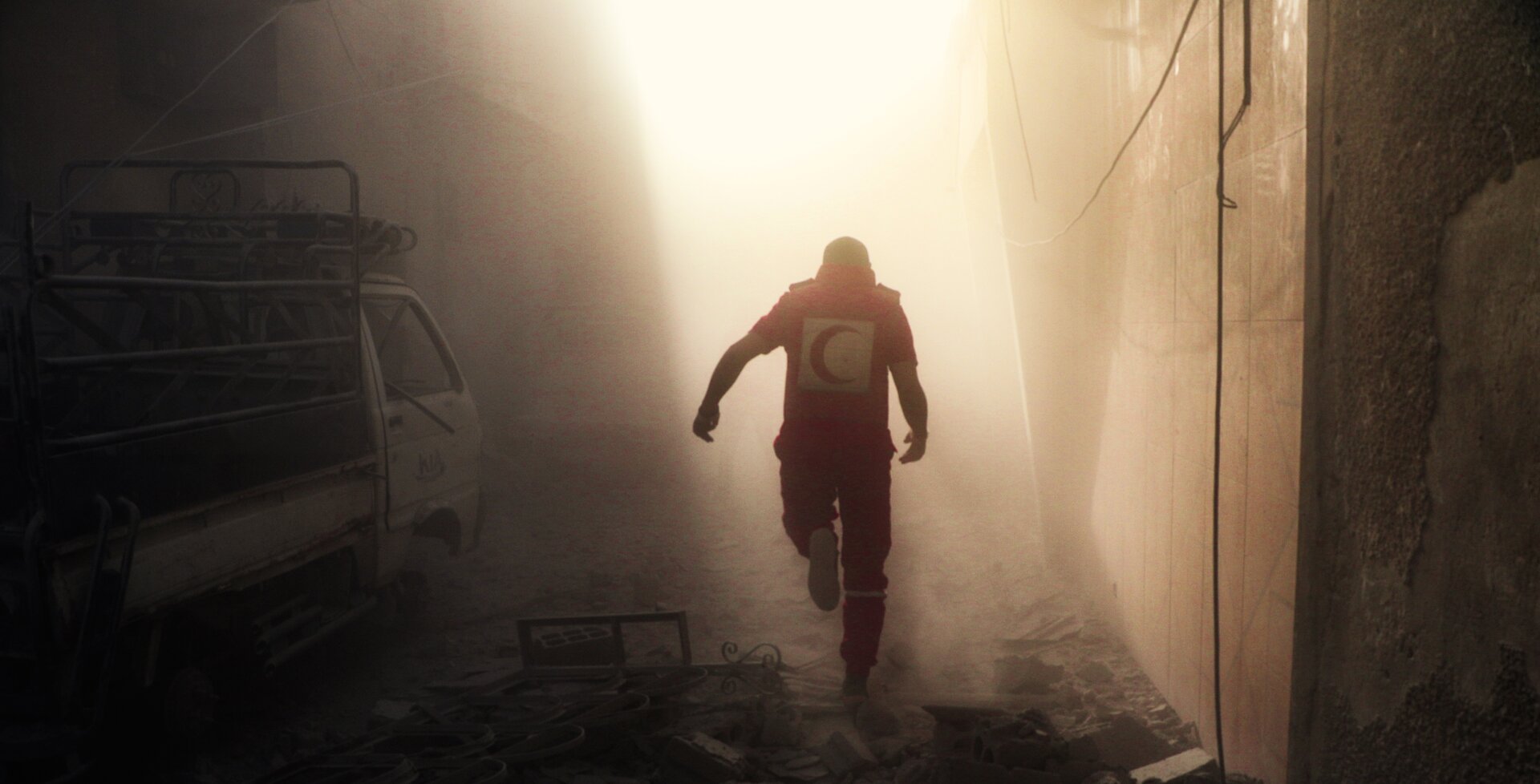 Humanitarian running through debris